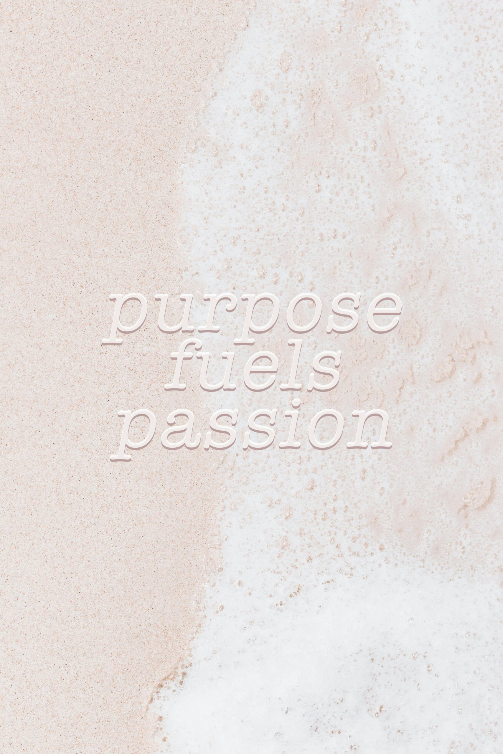 Motivational quote 'Purpose fuels passion' on a sandy beach with foamy waves.